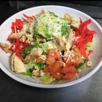 Cilantro Chicken Caesar Salad · Chicken, avocado, tomato, chips and Parmesan cheese.