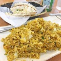 Chicken Biryani · Basmati rice cooked with boneless chicken and spices. Served with raita (yogurt).
