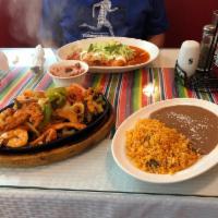 Chicken Fajitas · Fresh grilled strips of chicken, or shrimp cooked with onions, tomatoes, and green peppers -...