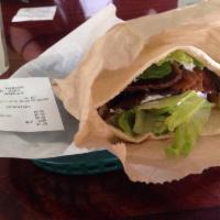 Gyro Sandwich · Juicy slices of gyros stuffed in pita bread with lettuce, tomatoes, parsley and onions and t...