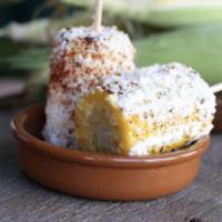 Elotes · Corn on the cob rubbed with mayo, crema Mexicana, queso cotija and chili powder.
