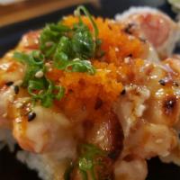 Baked Baby Lobster Roll · California roll topped with langostino lobster, smelt egg, scallion, sesame seeds, and eel s...