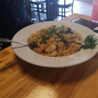 Pineapple Fried Rice · Exotic fried rice with pineapple, raisin, tomato, onion, egg, chicken, and shrimp topped wit...