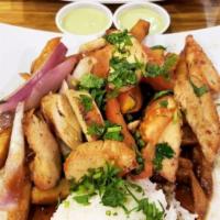 Pollo Saltado · Tender strips of chicken, Roma tomatoes and red onions sauteed and served over french fries ...