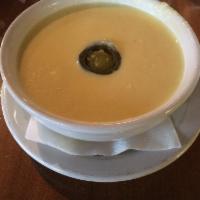 Corn Soup · Creamy corn soup topped with a jalapeno. 