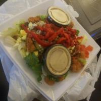 Cobb Salad · 370 calories. Romaine and Iceberg blend, breaded chicken, bacon pieces, tomatoes, avocado, e...