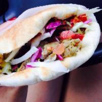 Shawarma Sandwich · Thin slices of lightly seasoned turkey and lamb served in pita pocket with hummus lettuce, t...