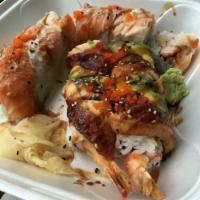 Dragon Roll · Shrimp tempura, crabmeat, masago topped with eel, avocado and eel sauce.
