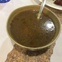 Mutton Bone Soup · Long simmered goat bone soup flavored with coconut milk and spices. Spicy.