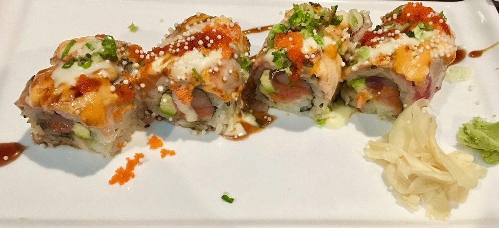 Spectrum Roll · Tuna, salmon, yellowtail and avocado inside with tuna and salmon outside. Lightly torched with Japanese mayo and spicy mayo. Topped with tobiko, rich crunch and scallion. Drizzled with eel and sweet wasabi sauce.