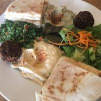 Mediterranean Platter · House-made hummus, baba ganouj, tabbouleh salad, falafel and dolma served with warm pita bre...