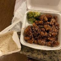 Sesame Chicken · Large pieces of chicken, deep fried until crispy, sauteed in brown sauce with sesame seeds.