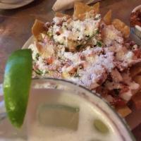 Chips Rancheros · Nachos platter with Re-fried beans, homemade tortilla chips, melted cheeses, pico de gallo, ...