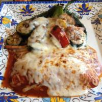 Chile Rellenos · 2 fresh grilled pasilla chiles stuffed with fresh vegetables, covered with cheese and baked....