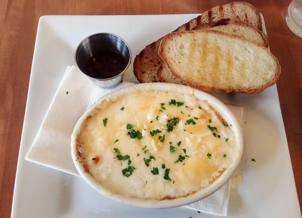 Baked Eggs · 2 baked eggs with Parmesan cream sauce, Swiss cheese and fresh herbs. Comes in it's own terrine served with rustic italian bread. Add bacon, shaved ham, sausage gravy for an additional charge.
