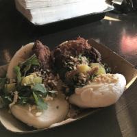 Chicken Bao · Fried chicken, oyster aioli, crushed peanuts and pickled radish.