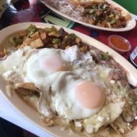 Chilaquiles · Corn tortilla chips with eggs any way mixed with a red or green sauce or both, choice of bea...