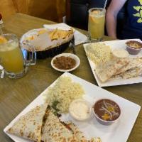 Quesadillas · Choice of meat grilled with peppers onions & melted mozzarella cheese wrapped in flour torti...