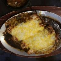 Enchiladas · Corn tortillas dipped in homemade mole your choice of beef or chicken served with rice & red...
