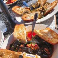 Zuppa Vongole · A large bowl of fresh native littlenecks in a garlic lemon herb cam sauce, your choice of re...