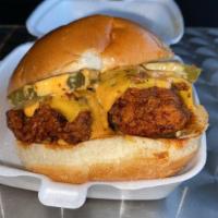 Nashville Hot Chicken · Battered Chicken dipped in Hot Oil, American Cheese, Pickle, Nashville Sauce