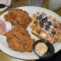Chicken and Waffles · Belgian waffles, two fried chicken breasts, honey butter, and syrup.