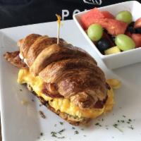 Sunrise Sammy Breakfast · Organic scrambled eggs, bacon, cheddar cheese on croissant served with a side of fresh fruits.