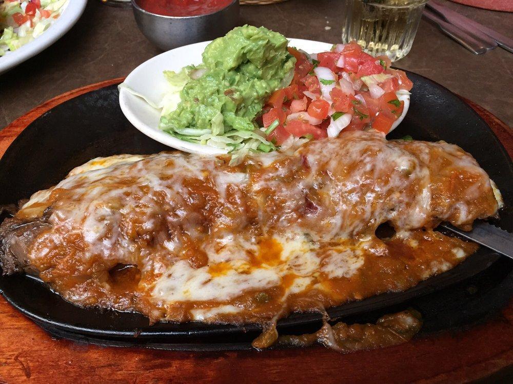 Steak Ranchero · Seasoned charbroiled skirt steak topped with ranchero sauce and Monterey Jack cheese and guacamole. Served with Spanish rice, borracho beans and fresh flour tortillas.