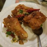 Salt and Pepper Chicken Wings · This dish has been our most popular dish for over 40 years. Cooked wing of a chicken coated ...