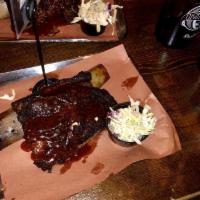 Brontosaurus Rib · On-the-bone, slow-smoked short rib with almost a full pound of meat on the rib. Served with ...