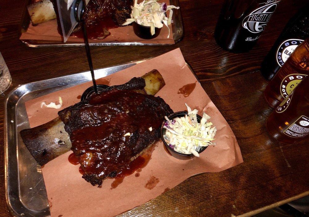 Brontosaurus Rib · On-the-bone, slow-smoked short rib with almost a full pound of meat on the rib. Served with an optional assortment of pickled veggies & slaw.