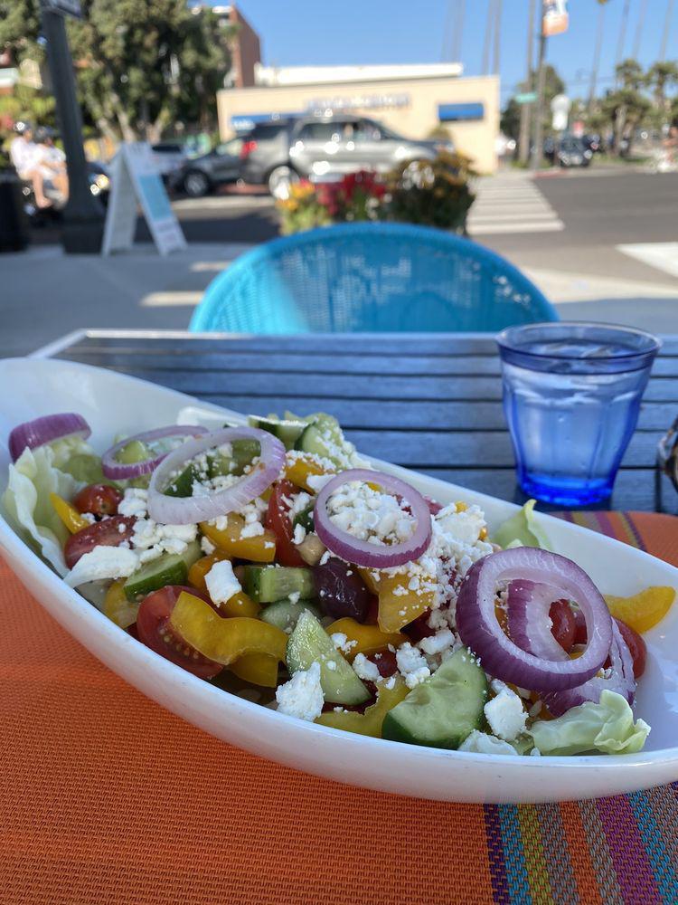 Greek Salad · Vegetarian, gluten-free. Grape tomatoes, red onions, Kalamata, olives, feta cheese, Persian cucumbers, organic garbanzo beans, bell peppers, with fresh-squeezed lemon juice and olive oil.