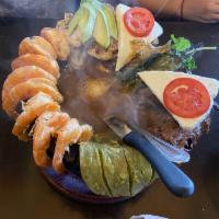 Molcajete Trio · Grilled steak, chicken and shrimp. Served with a side of salsa de molcajete.