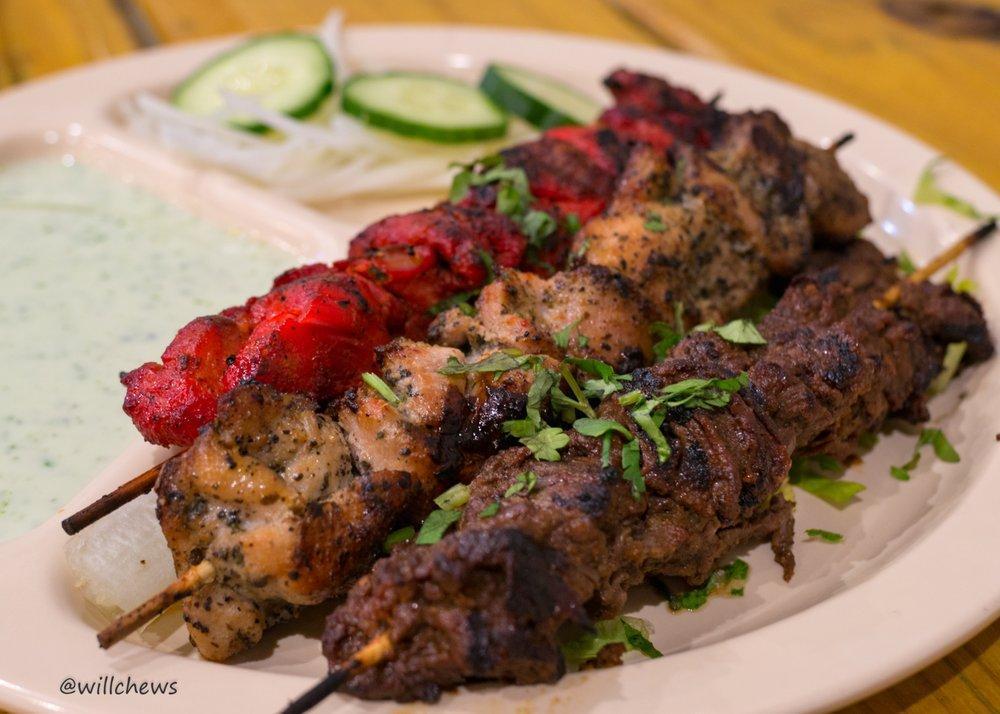 Mixed Karachi Grilled Kabab Platter · 1 beef, 1 tandoori chicken and 1 Mediterranean chicken kabab marinated over 24 hour in exotic herbs and spices, skewered on 3 bamboo sticks. Served with butter-sauteed pita bread, spicy yogurt sauce, chopped onion and freshly sliced cucumbers.