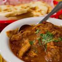 Karahi Chicken · Tender chicken coated in tomato sauce, chilly peppers, Indian herbs and spices.