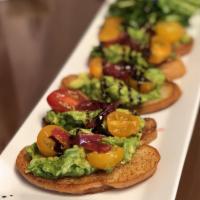 Avocado Toast · Smashed avocado, heirloom tomatoes, mixed greens, pickled onion, EVOO and garlic toast