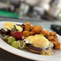 Eggs Benedict · Carved slab bacon atop a toasted english muffin, poached eggs and Hollandaise. Served with b...