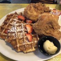 Chicken and Waffles · Belgian style waffles, two fried chicken breasts, honey butter, and syrup.