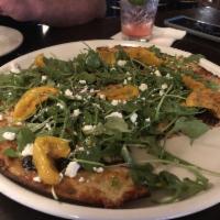 Fig Jam and Arugula Pizza · Served with goat cheese, onion and marinate oven-dried tomatoes.
