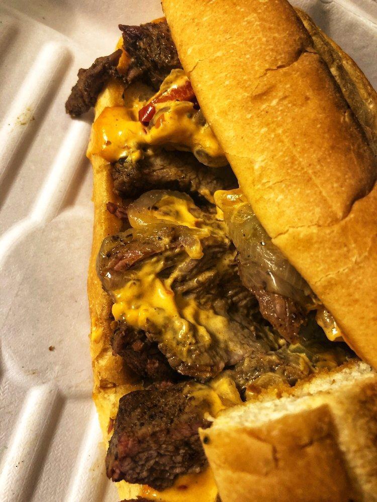 Urban Cowboy Sandwich · Lime-marinated steak, caramelized onions, and peppers, pepper jack, aioli on a French roll.