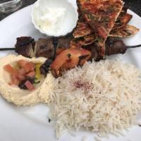 Beef Kebab · Grilled marinated beef tenderloin served with hummus, roasted tomatoes, and crispy pita. Cho...
