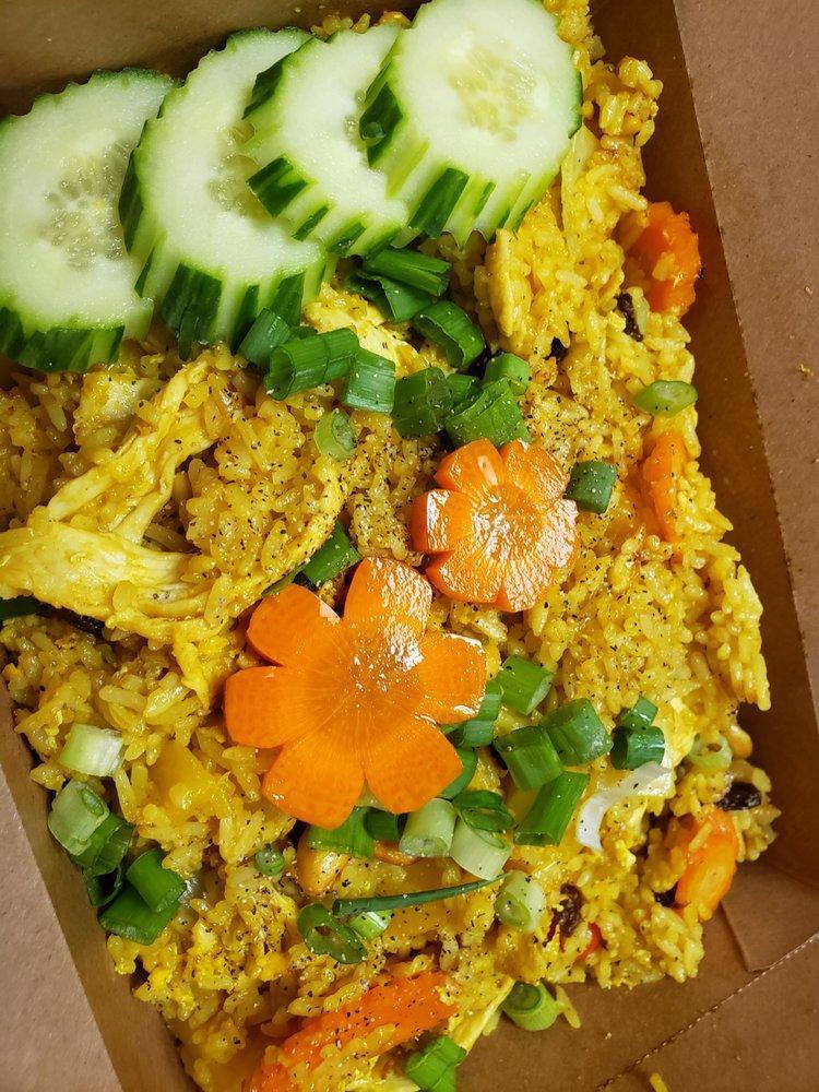 Pineapple Fried Rice · Stir-fried jasmine rice, pineapple, eggs, onion, carrot, tomato and house soy sauce.