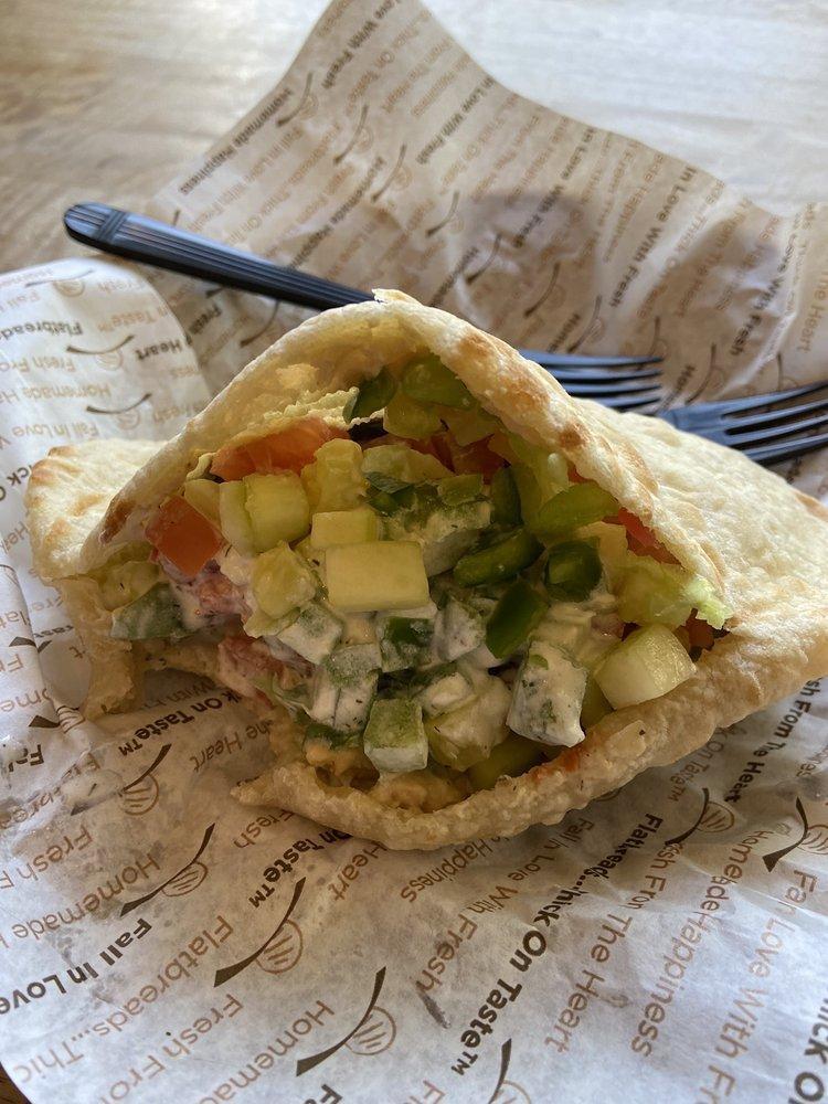 Chicken Hummus Pita Pocket · Skewered, all white meat, charbroiled chicken cubes marinated and seasoned with our specialty Mediterranean flavors, topped with romaine lettuce, shepherd salad and a scoop of hummus, with choice of yogurt-cucumber, red hot sauce or green tahini.
