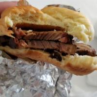 Sliced BBQ Brisket Sandwich · Covered in Hecky's famous BBQ sauce.