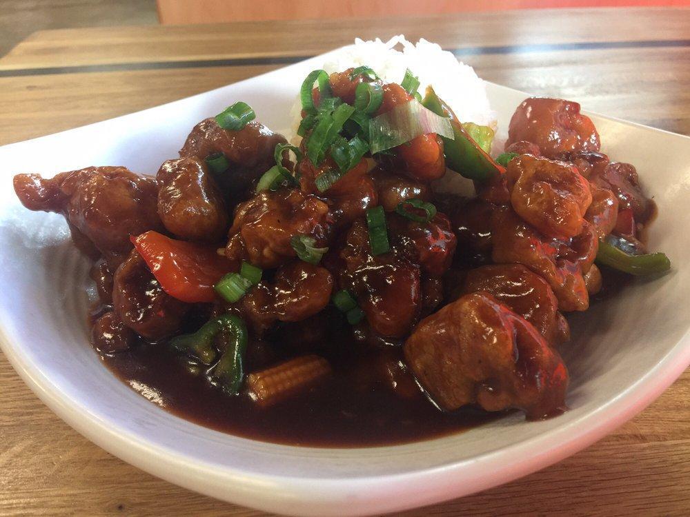 General Tso Chicken · Hand cut and battered chicken bites are wok-tossed with a tangy samba sauce with babycorn. Garnished with chopped green onions. Served with a steamed rice. Made not spicy. (Gluten-free)
