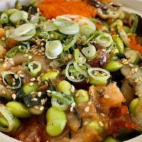 Spicy Tuna · Spicy tuna, scallion, nori seaweed, sesame seeds, and crispy onions with umami soy sauce.