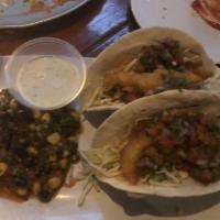 Baja Fish Tacos · beer-battered, pico de gallo, guacamole, black bean salad, shredded cabbage, tequila-lime ai...
