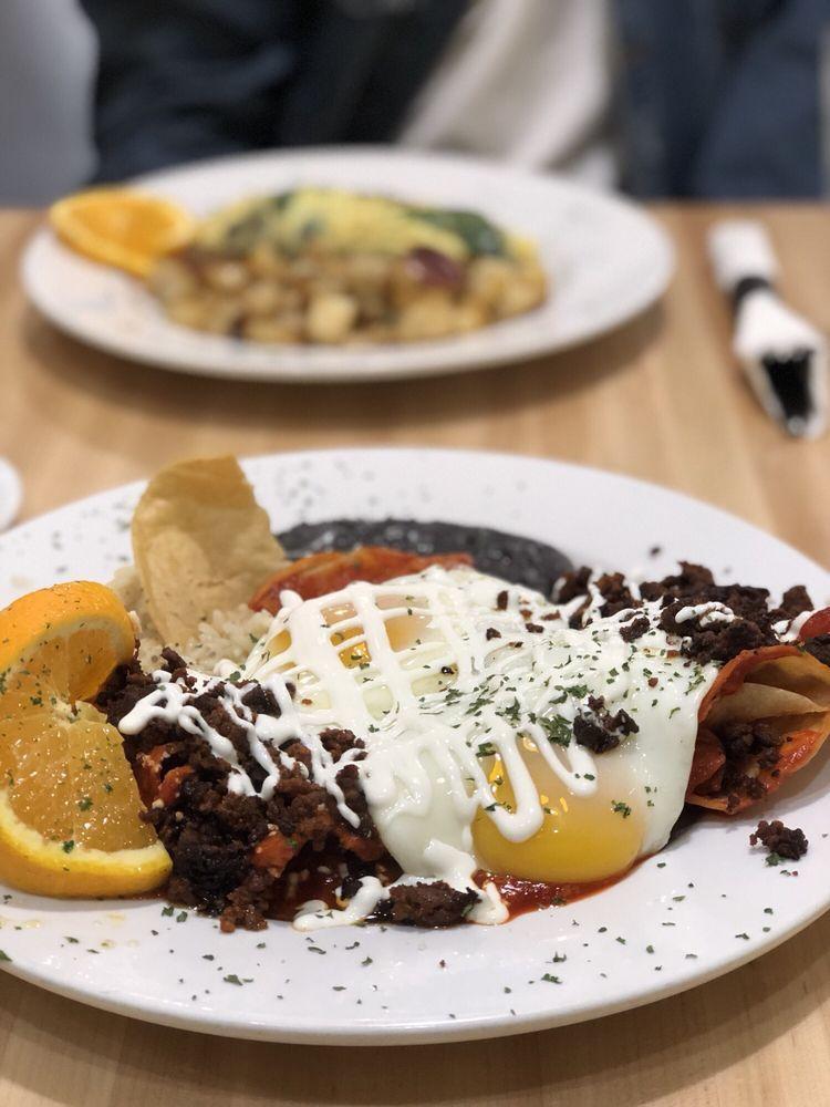 Zinnia's Spicy Chilaquiles · Two eggs any style, tortilla chips in our home made salsa Rosa or verde, pepper jack cheese, cotija cheese, sour cream, served with rice and beans.