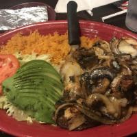 La Parrilla Especial · Grilled choice ribeye and boneless chicken breast topped with onions and mushrooms. Served w...