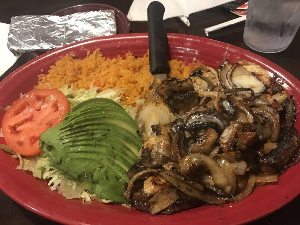 La Parrilla Especial · Grilled choice ribeye and boneless chicken breast topped with onions and mushrooms. Served with rice and avocado salad.
